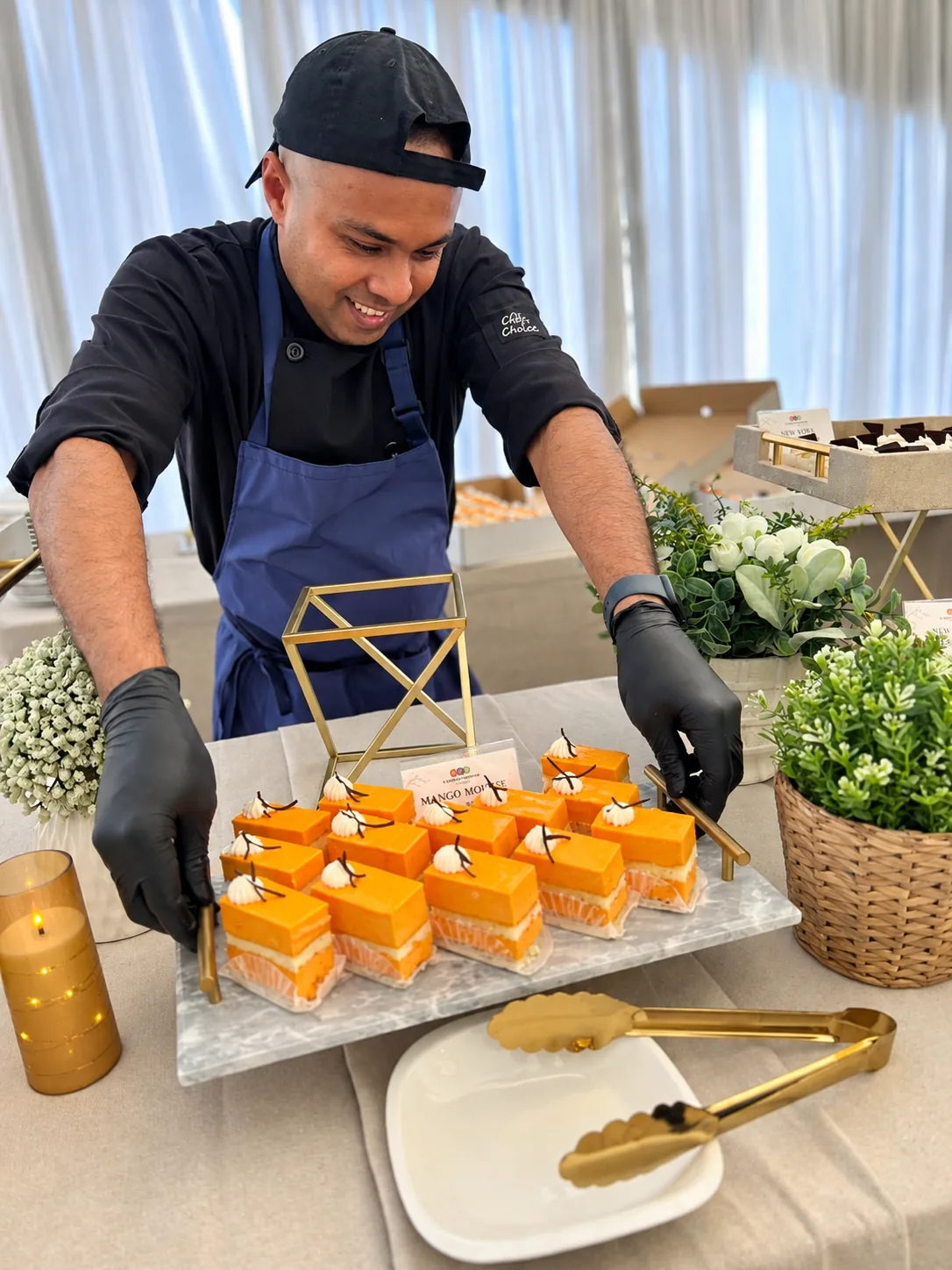 A chef setting out mango mousse at a dessert station