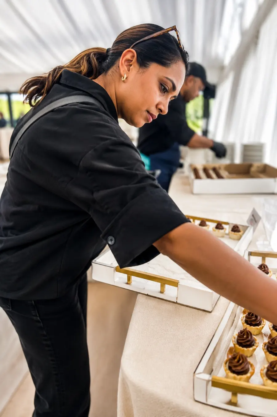 Arranging dessert trays at an event