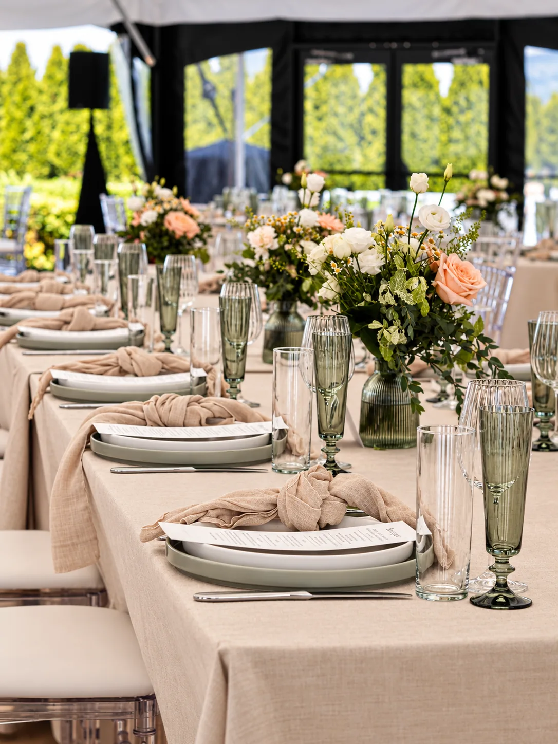A marquee long table laid for a reception
