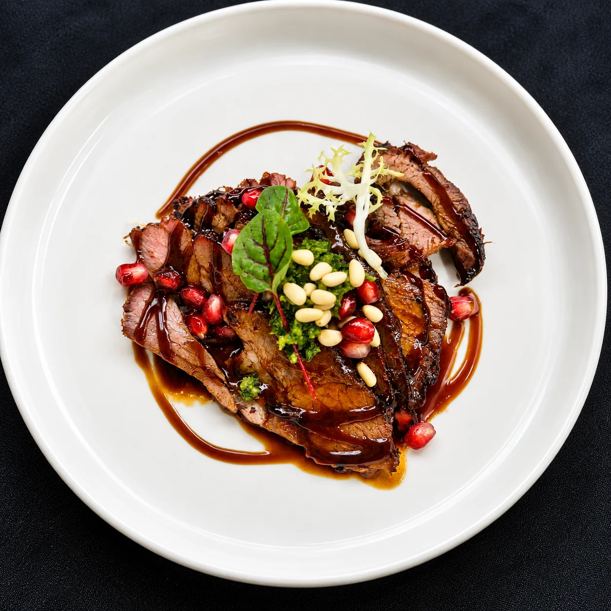 Sliced roast with pomegranate, pine nuts and salsa verde