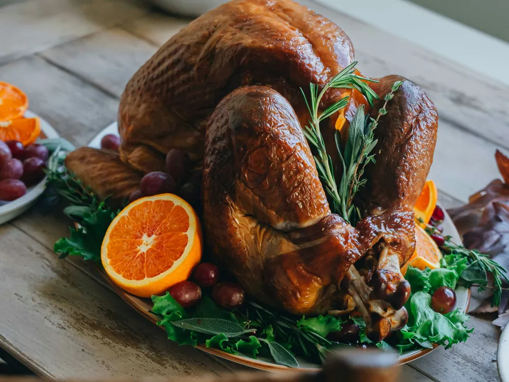 Herb-roasted turkey, garnished and ready to carve