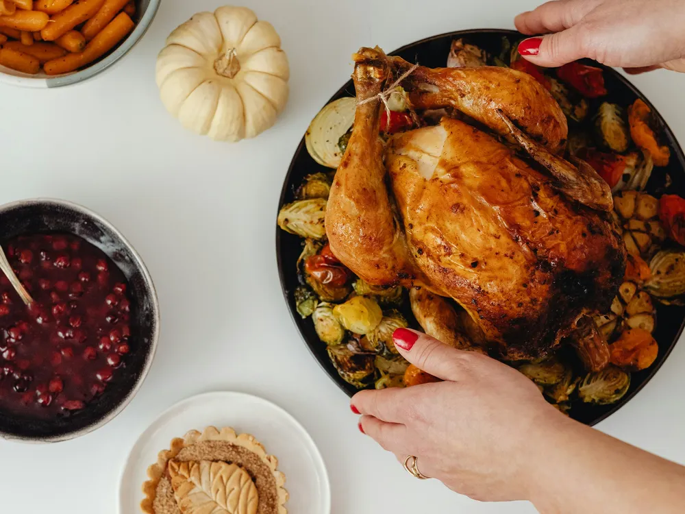 A roast carried to the table with its sides